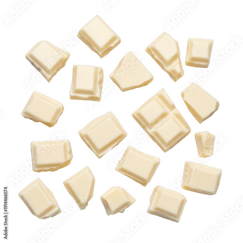Assorted white chocolate pieces scattered on a white background