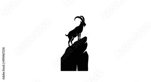 Silhouette of a Mountain Goat on Rocky Outcrop at Sunset