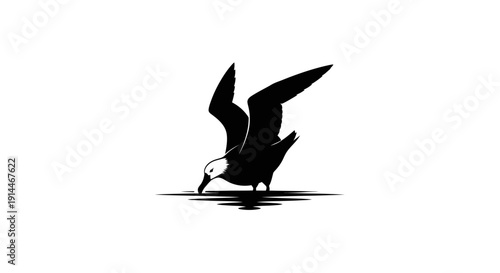 Silhouette of a bird perching on water at dusk
