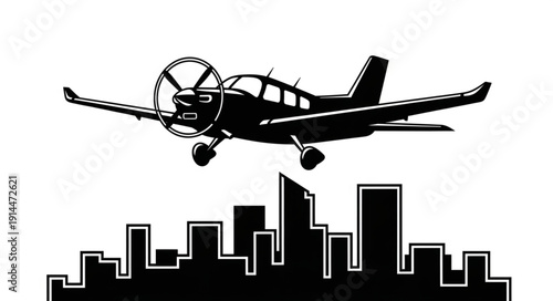 Small airplane flying over a city skyline silhouette.