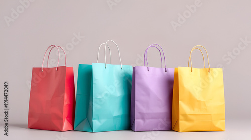 Isolated multicolored paper shopping bags for carrying products, sale or gifts on a surface