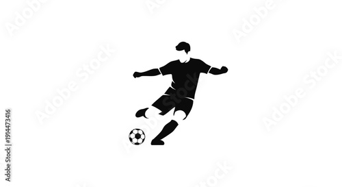 Silhouette of a Soccer Player Kicking Ball