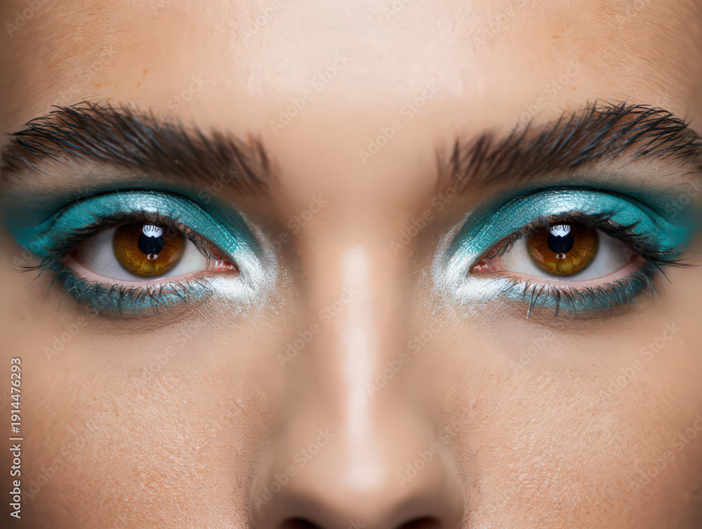 Obraz premium Striking Teal Eye Makeup A Close-Up of a Woman's Eyes with Bold Teal Eyeshadow and Defined Brows A Detailed and Artistic Cosmetic Look