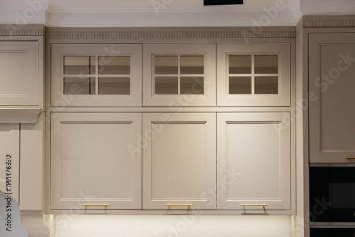 Modern luxury kitchen interior with beige cabinets and navy blue island.