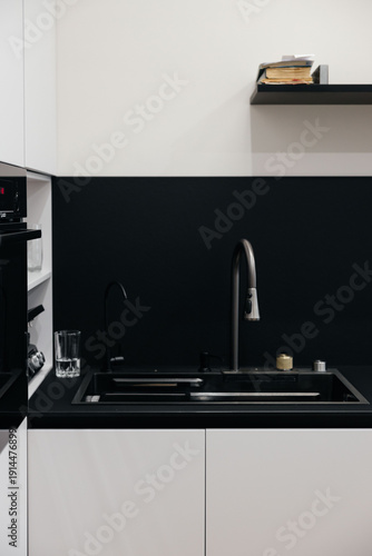 Modern luxury kitchen interior with beige cabinets and navy blue island.