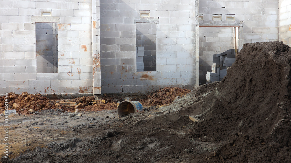Naklejka premium Construction site with a pile of dirt and a concrete building foundation IMG 4380 under development
