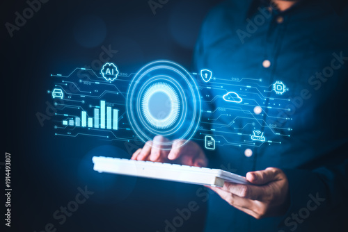 Business professional using keyboard with hologram AI interface overlay showing global data analytics cybersecurity and cloud computing in modern enterprise workspace