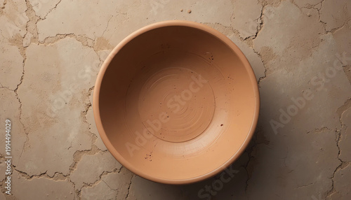 Empty clay bowl top view on neutral surface, handmade earthen texture, soft even lighting, minimal composition, professional stock photography style, no text, no people, high resolution
