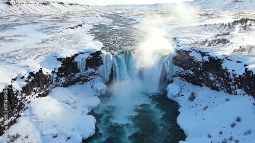 Wallpaper Mural Powerful icy waterfall crashes through snowy canyon landscape under bright sun Torontodigital.ca