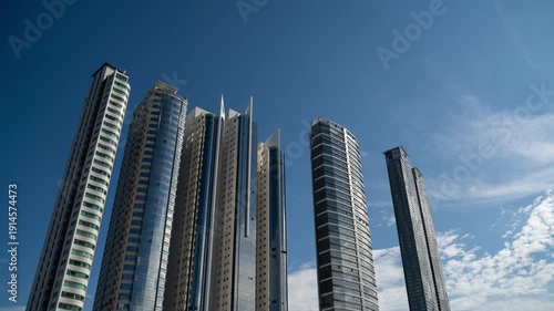 Timelapse of skyscrapers against a blue sky in Balneário Camboriú, Brazil