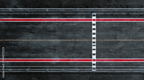 An aerial view of a race track. The asphalt surface is marked with red and white lines, creating a sense of speed and direction