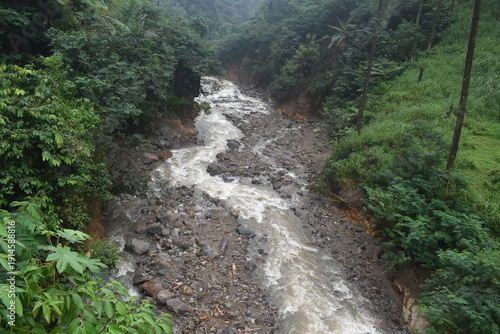 The dramatic flooding and landslides of a waterfall in Pekalongan. The water is cloudy.