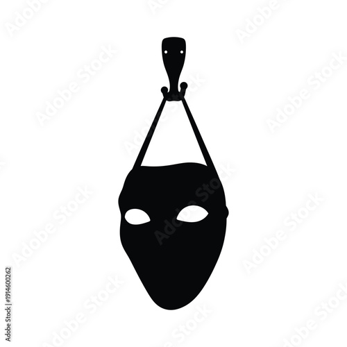 Black silhouette vector illustration of an alien mask hanging on a hook, eerie and mysterious