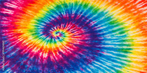 A psychedelic digital art wallpaper featuring an abstract colorful rainbow background with a fractal geometric flower design, swirling textures, and a vibrant explosion of light and color