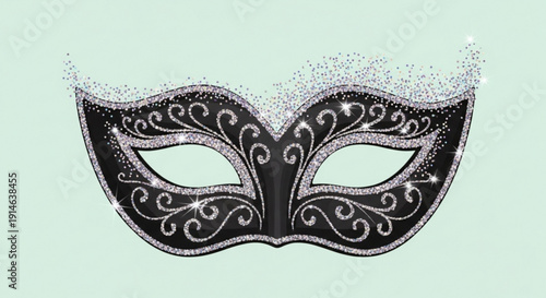 Intricately designed black masquerade mask with silver swirls on a light green background for carnival or party use