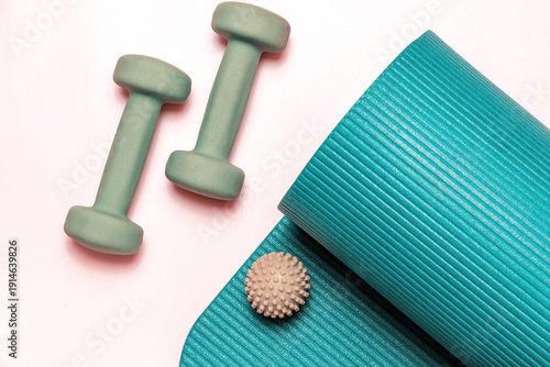 Fitness equip with dumbbells, yoga mat, and massage ball for home workouts and wellness. Perfect for health, exercise, and active lifestyles