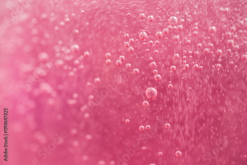 Tableau sur toile Bubbles floating in pink liquid with bright background