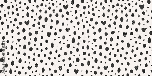 Abstract pattern of scattered black blobs and heart shapes on white