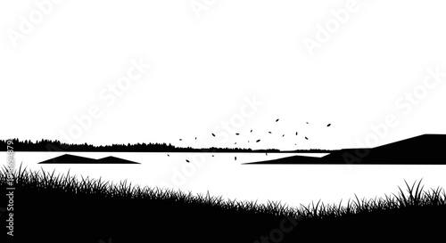 A serene silhouette of a calm lake with distant trees and a grassy foreground under a vast sky