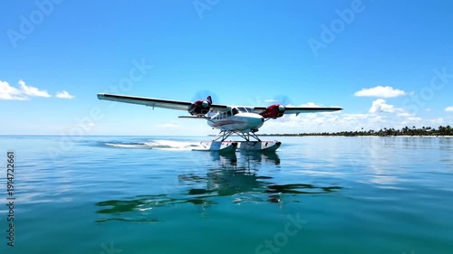 Small seaplane flying over turquoise water with clear sky and distant shoreline for travel tourism and transportation concepts