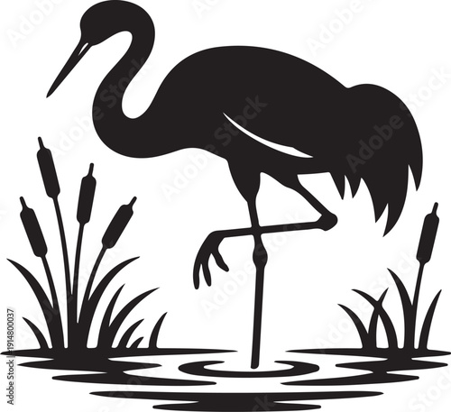 Black crane standing in water with reeds silhouette