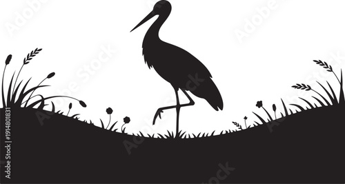 Black silhouette of a bird standing on grassy terrain with plants