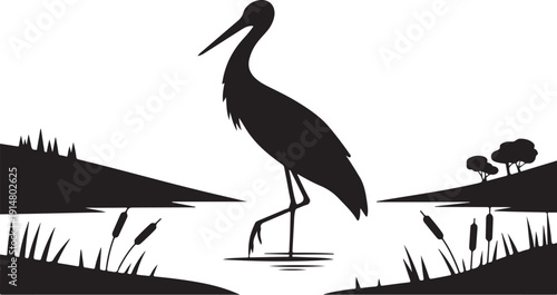 Black silhouette of a crane standing in water with reeds and trees