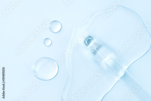 Wallpaper Mural Drop of cosmetics and a pipette on a blue background. A product for skin, face or hair care. Torontodigital.ca