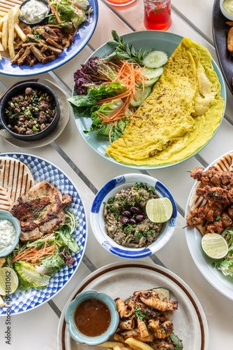 Wallpaper Mural many different mediterranean food dishes on restaurant table in greece Torontodigital.ca