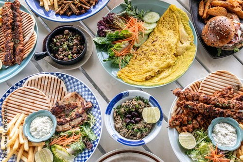 Wallpaper Mural many different mediterranean food dishes on restaurant table in greece Torontodigital.ca