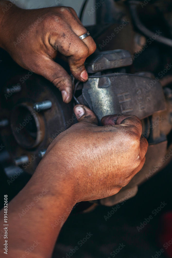 Obraz premium Vertical Mechanic man hands repairing car shop. Man hands fixing Car machinery vehicle mechanical service. Vertical horizon vehicle hood checking automobile. Car motor Workshop oil garage maintenance