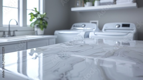 Shiny marble-patterned countertop in a modern laundry room with appliances, sink, and window