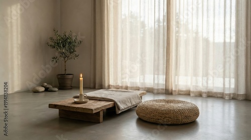 A candle is lit on a wooden table in a room with a window