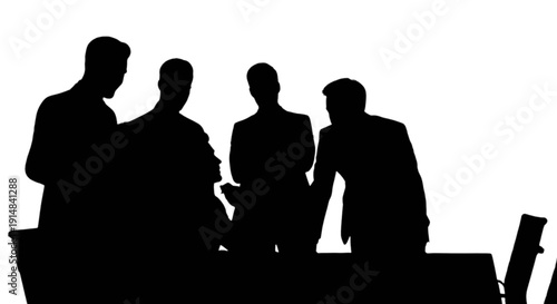 Silhouettes of people gathered around a table in a dimly lit room