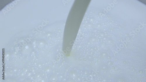 Wallpaper Mural 4K Close-up view of fresh milk being poured smooth texture bubbles and creamy white surface, minimal and clean composition highlights purity freshness and dairy nutrition concepts. Torontodigital.ca