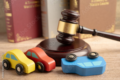 Fotografie Car accident lawsuit and insurance, Judge hammer with car model.