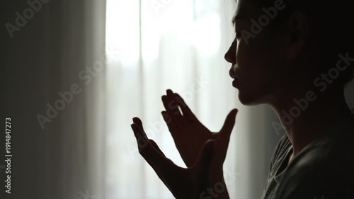  Silhouette of Person hands open palm up worship God helping repent catholic easter lent mind pray Christian religion.  prayer woman worship God in the morning with sunrise.