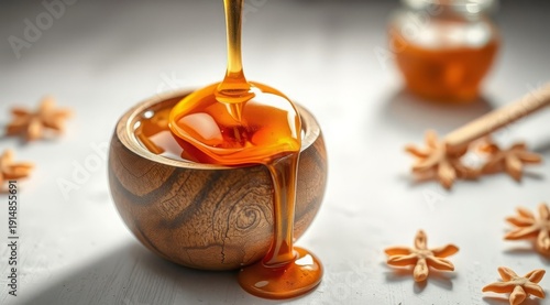 Close-up of honey pouring into a wooden bowl, with droplets around it. A warm, natural composition suitable for culinary, wellness, and eco-friendly projects.