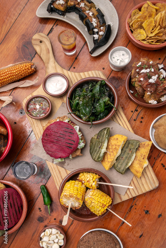 Wallpaper Mural mixed colombian and venezuelan food meal spread on wooden restaurant table Torontodigital.ca