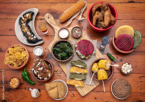 Wallpaper Mural mixed colombian and venezuelan food meal spread on wooden restaurant table Torontodigital.ca