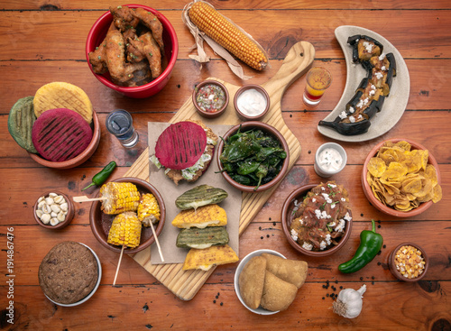 Wallpaper Mural mixed colombian and venezuelan food meal spread on wooden restaurant table Torontodigital.ca