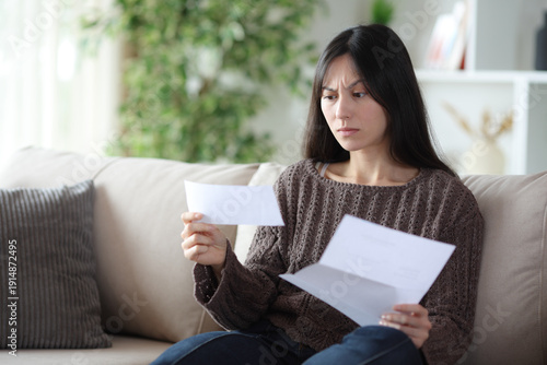 Photos Worried asian woman reading bad news in a letter