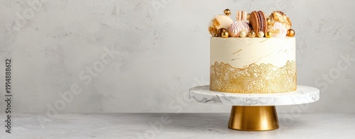 The cake on marble stand with gold accents and elegant dessert decorations