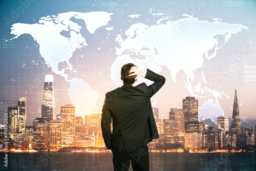 Businessman looking at digital world map overlay on San Francisco skyline, symbolizing global technology and decision-making concepts.