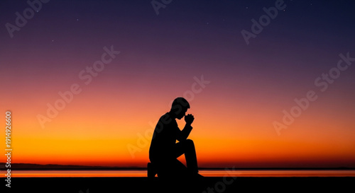 Man in contemplation sitting alone at serene sunset with peaceful water background