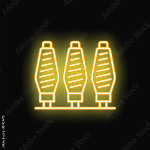 Yellow glowing neon icon of three thread bobbins for sewing on black background