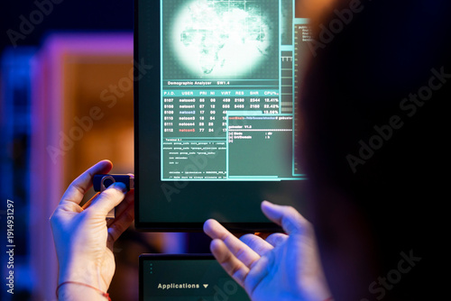 Canvas Print Close up of hacker at home using spyware on USB stick to gather data about user activity