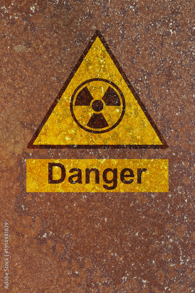 Obraz premium Danger radiation symbol sign on a rust background. Hazardous radiation danger risk concept.