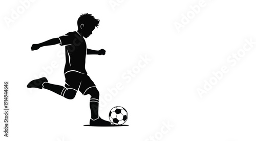 A young boy energetically kicking a ball in a dynamic pose silhouette