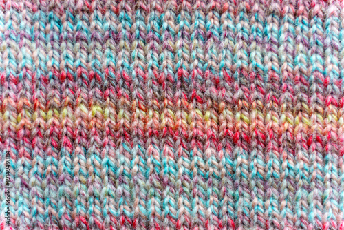 Close-up Texture of Handmade Knitted Clothing with Colorful Yarn Patterns